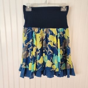 Free people whimsical skirt with multi colored floral pattern top layer is sheer